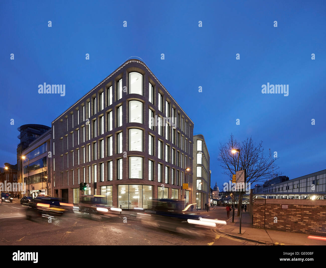 Gebäude mit Straßenszene in der Abenddämmerung. Turnmill Gebäude, London, Vereinigtes Königreich. Architekt: Piercy & Unternehmen, 2015. Stockfoto