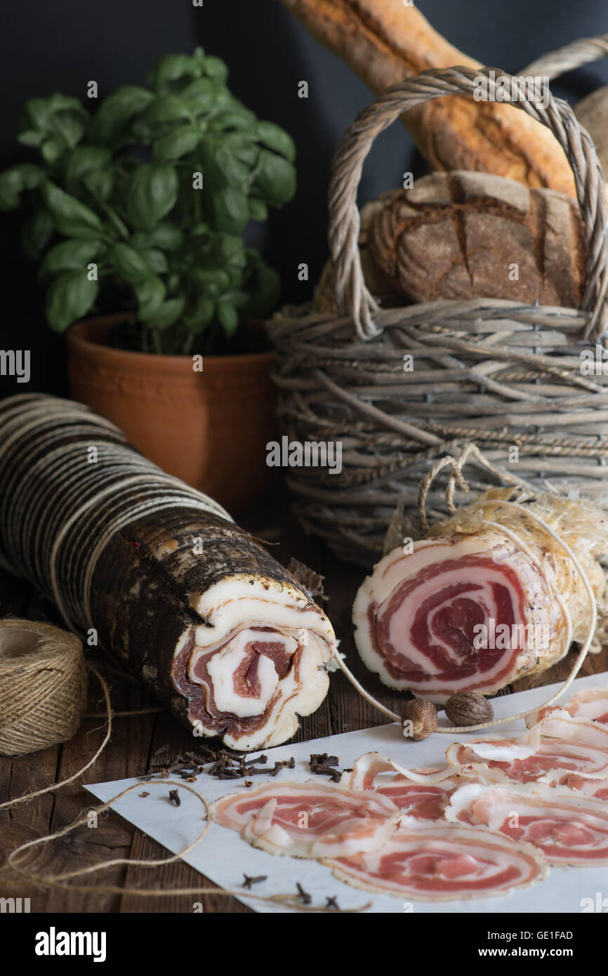 Pancetta-Scheiben, Basilikum und Brot Stockfoto