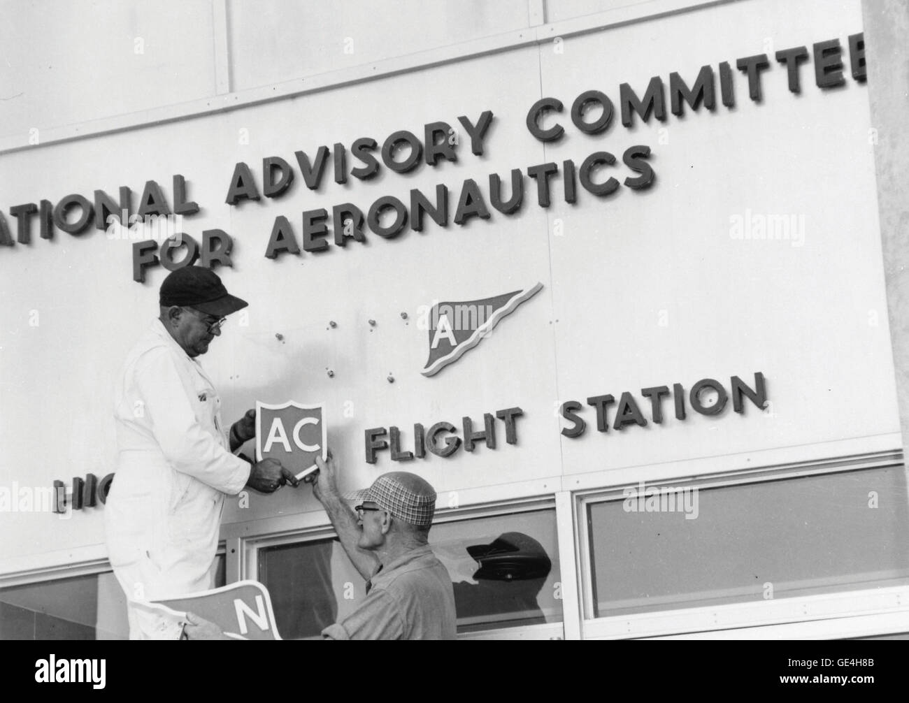 Dahl Matay und John Hedgepeth Sr. ändern das National Advisory Committee für Aeronautics (NACA) Zeichen an die NASA bei der Flight Research Center (jetzt Armstrong Flight Research Center) am ersten Tag, den NASA geöffnet für Geschäft.   Bild #: E96-43403-04 Datum: 1. Oktober 1958 Stockfoto
