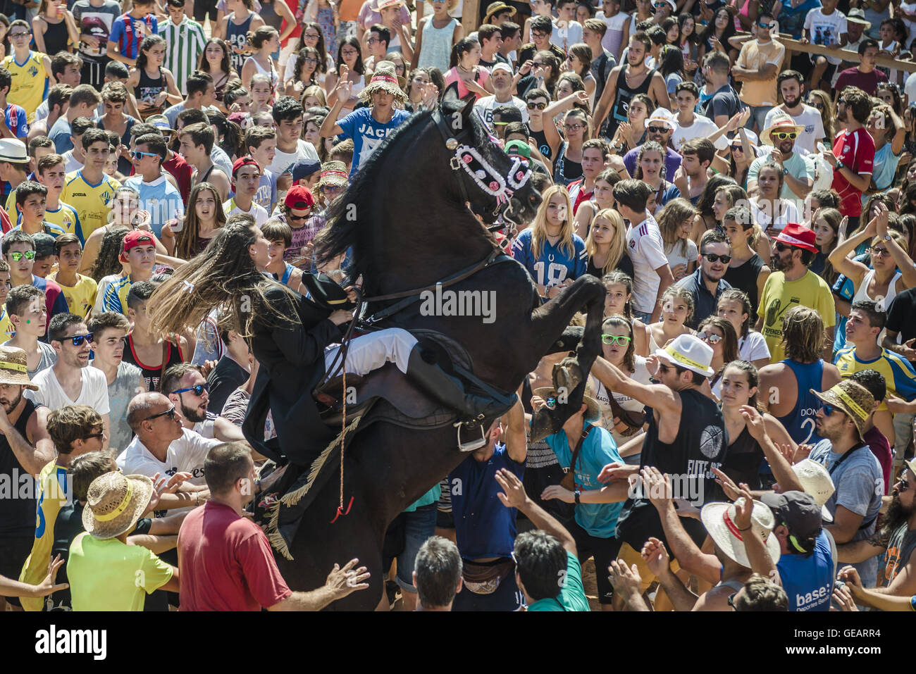 Es Castell, Balearen, Spanien. 25. Juli 2016. Ein "Caixer" (Reiter) bäumt sich auf seinem Pferd, umgeben von einer jubelnden Menge während der 2. "Jaleo" des traditionellen "Sant Jaume" (Jakobsweg) Festival in Es Castell, der Stadt Gönner Heiliges Fiesta Credit: Matthias Oesterle/ZUMA Draht/Alamy Live News Stockfoto