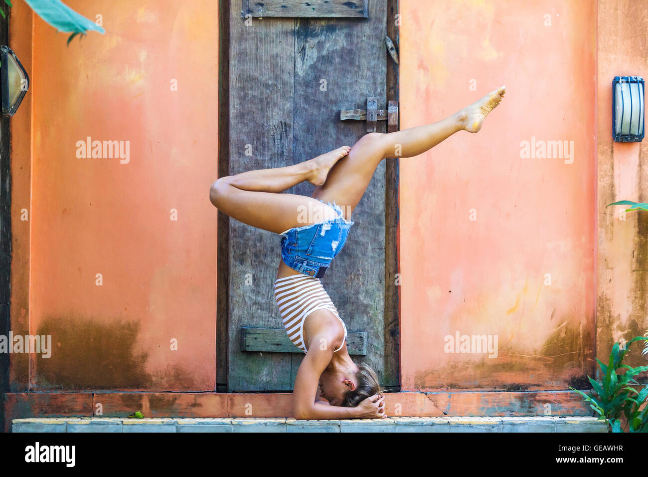 Junge Frau beim Yoga, Shirshasana Stockfoto