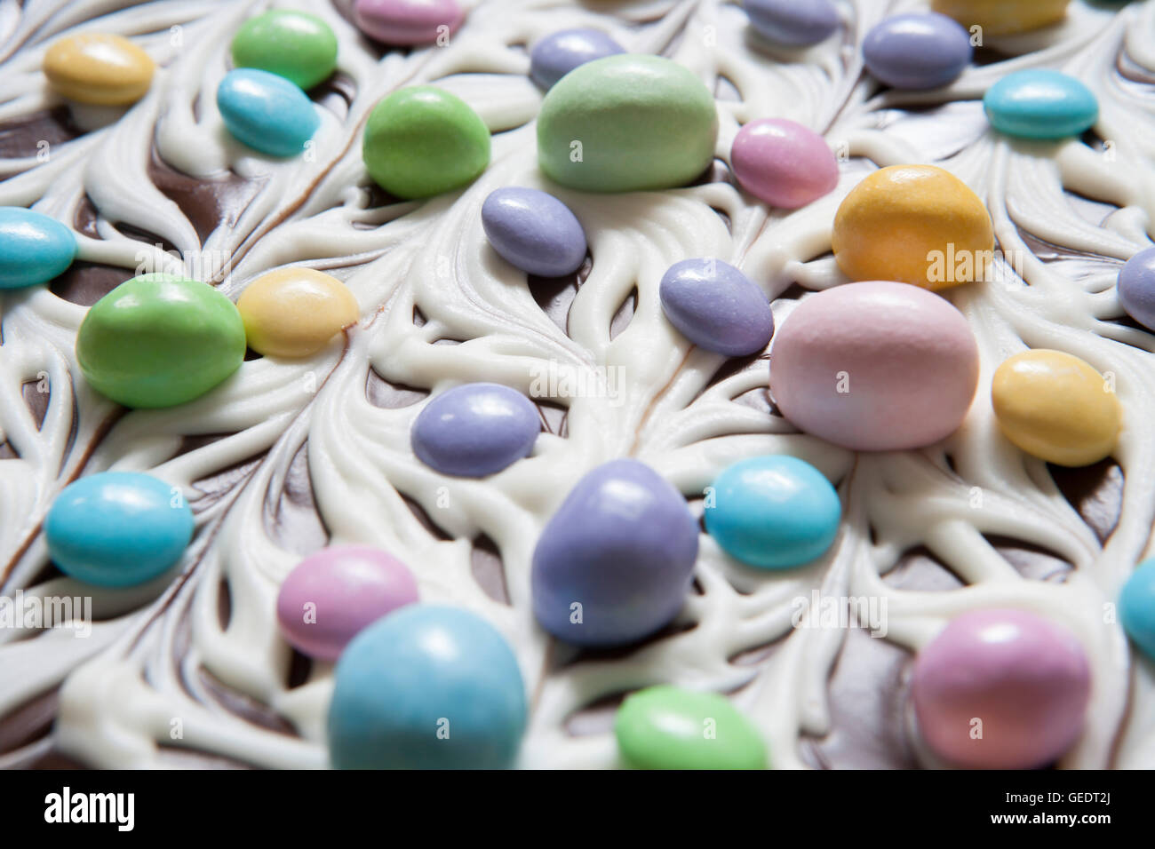 Marmorierte Schokolade Rinde mit Pastell Bonbons, Nahaufnahme Stockfoto