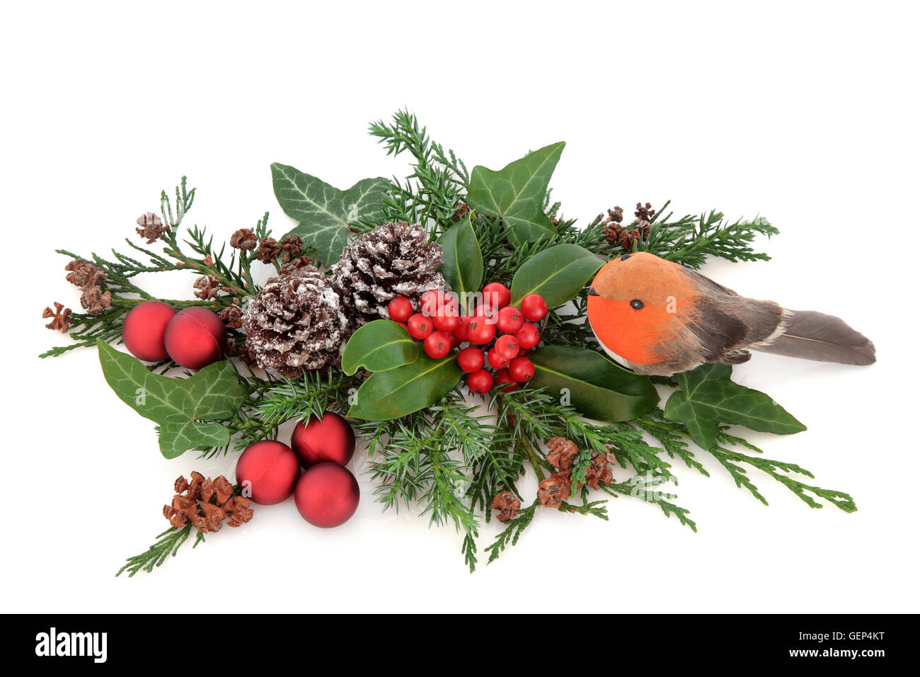 Floralen Weihnachtsdekoration mit Robin und Rote Christbaumkugel-Dekorationen, Holly, Efeu, Tannenzapfen, Zeder, Zypresse und Tanne über weiß. Stockfoto