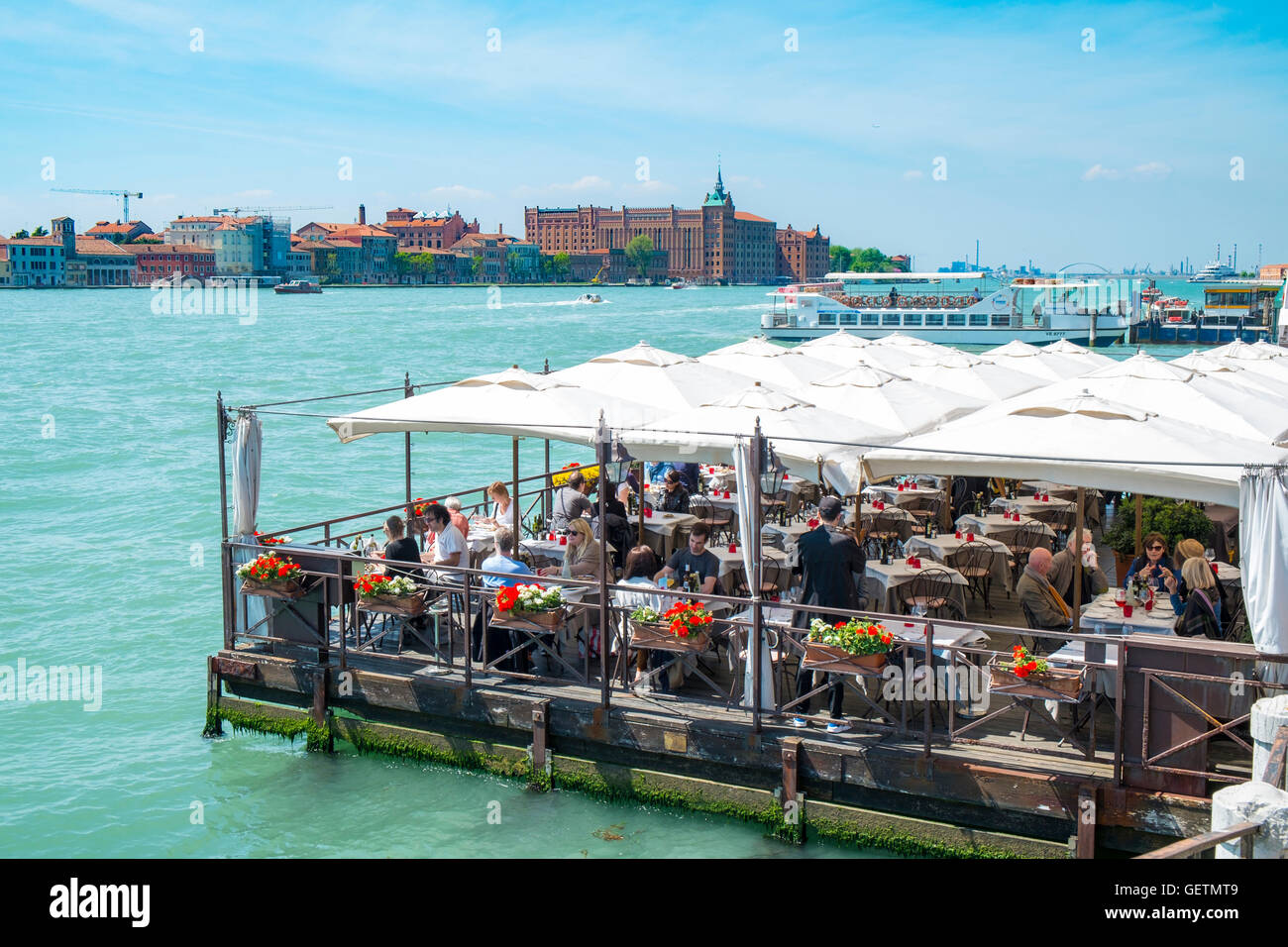 Gäste auf schwimmenden Ponton-Restaurant in Venedig. Stockfoto