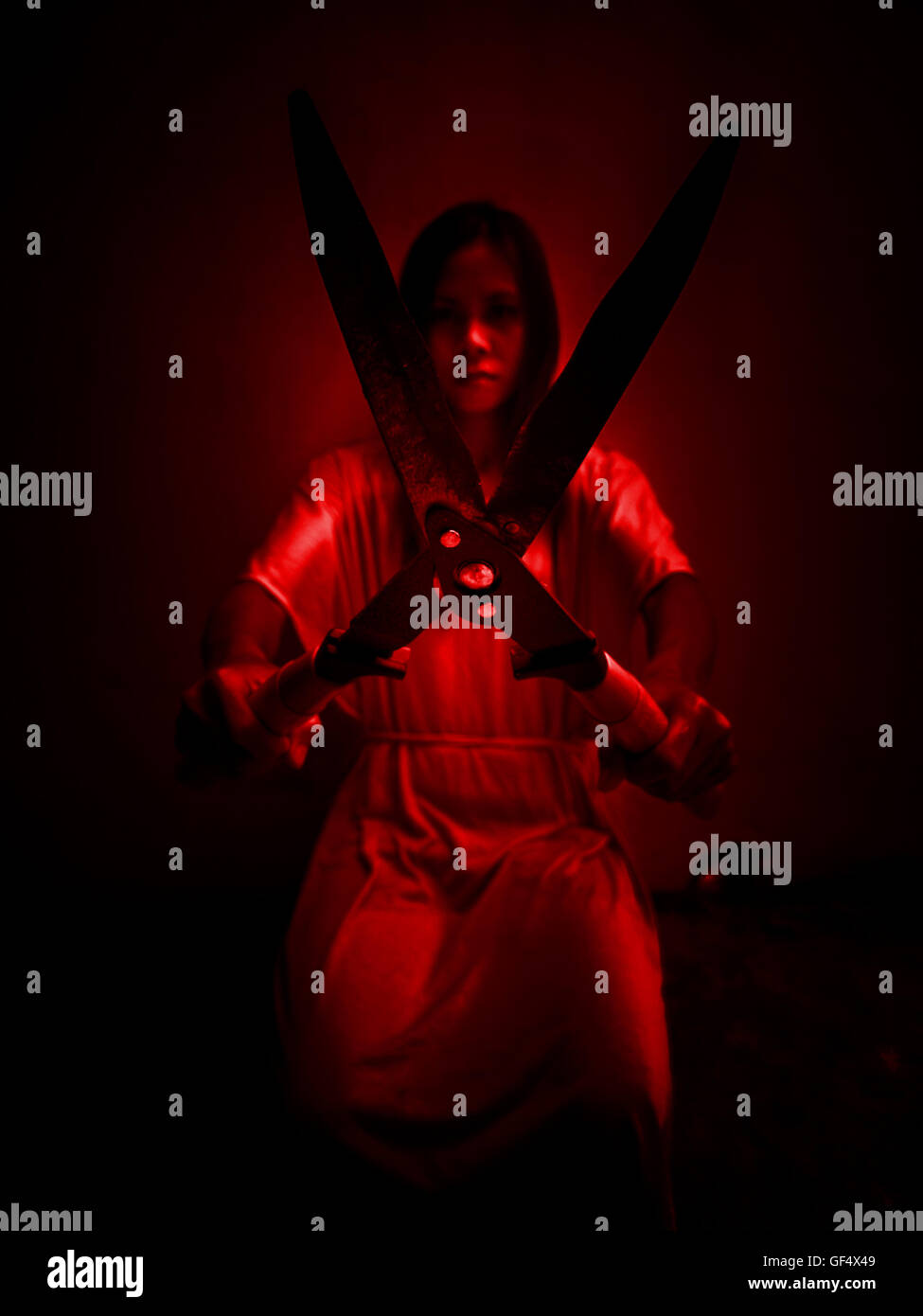 Horror-Szene Frau mit Rasen-Scheren, Serienmörder oder Gewalt Konzept Hintergrund Stockfoto