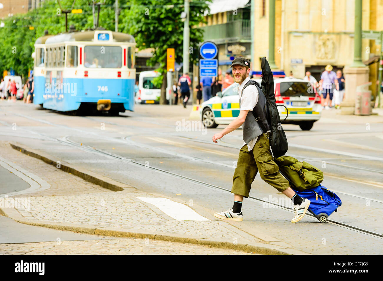 Göteborg, Schweden - 25. Juli 2016: Unbekannte Musiker zu Fuß auf der anderen Straßenseite einen Platz zum sitzen und spielen zu finden. Er hat ein guit Stockfoto