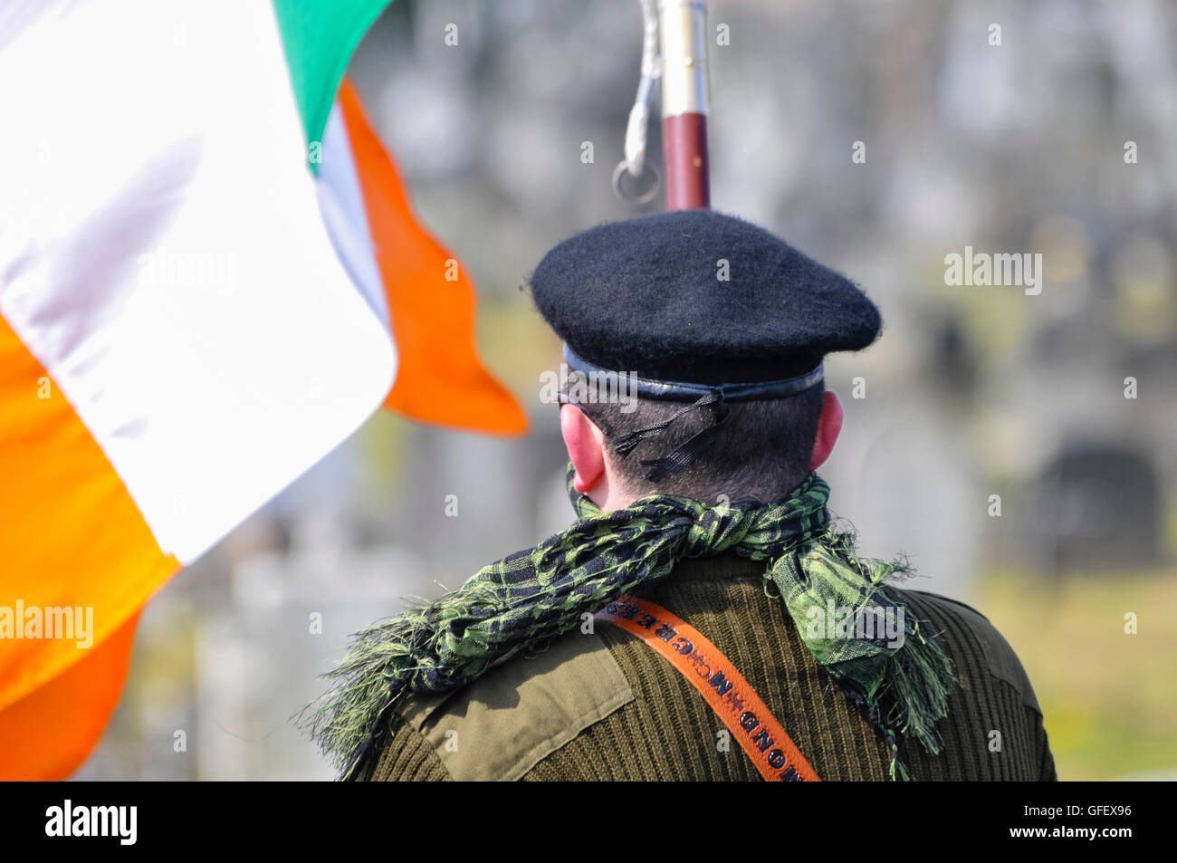 Ein Mann in paramilitärischen Uniform, mit einer irischen Trikolore wie Er erinnert an den Osteraufstand von 1916 Stockfoto