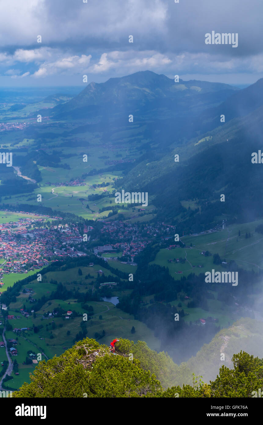 Weibliche Bergsteigen im Allgäu Berge mit Stadtbild von Oberstdorf im Hintergrund, Deutschland Stockfoto