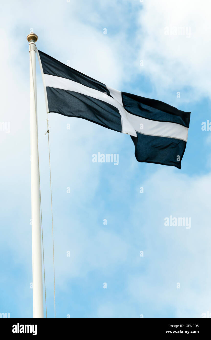 Das kornische Flagge hissen vor einem blauen Himmel. Stockfoto