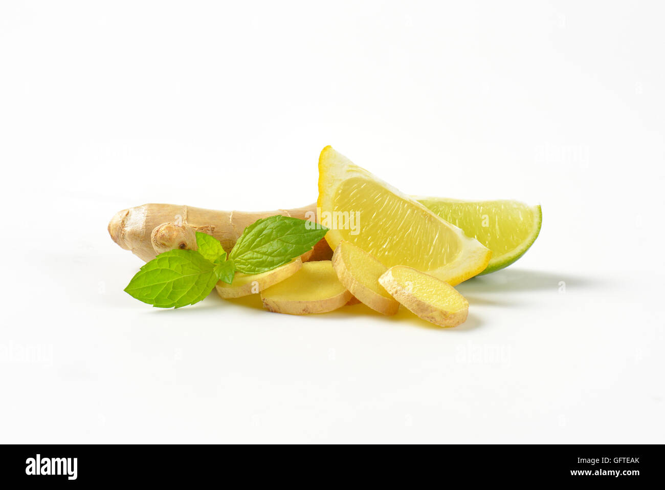 frischer Ingwer mit Zitrone und Limette auf weißem Hintergrund Stockfoto