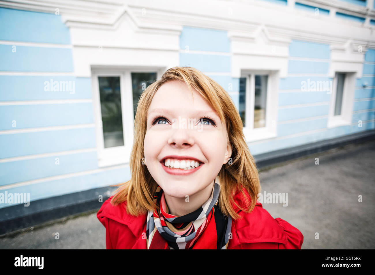Fröhliche junge Frau lächelnd auf der Straße Stockfoto