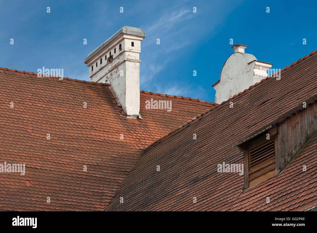 Hohen roten Ziegeldach mit Kamin und Gaube Fenster Stockfoto