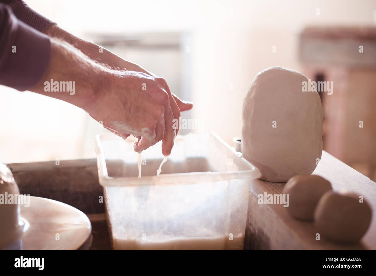 Männliche Potter Waschen der Hände nach der Arbeit an der Töpferscheibe Stockfoto