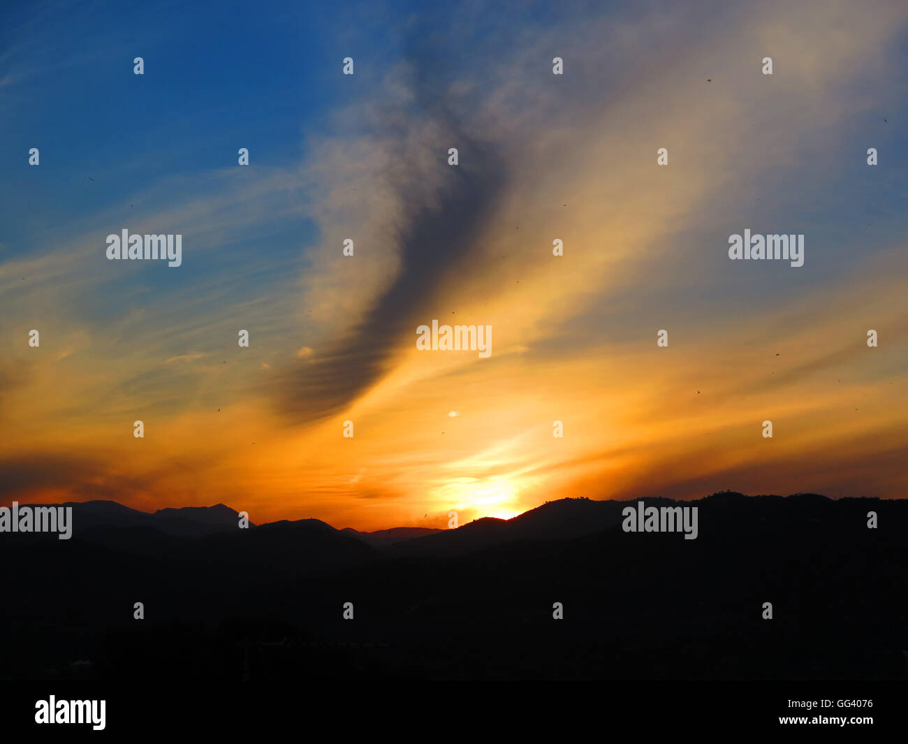 Silhouette in orange Dawn Wolken im Dorf von Alora Andalusien Stockfoto