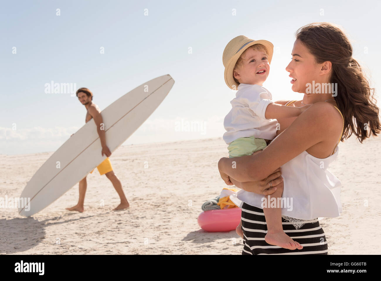 Glückliche junge Familie am Strand genießen Stockfoto