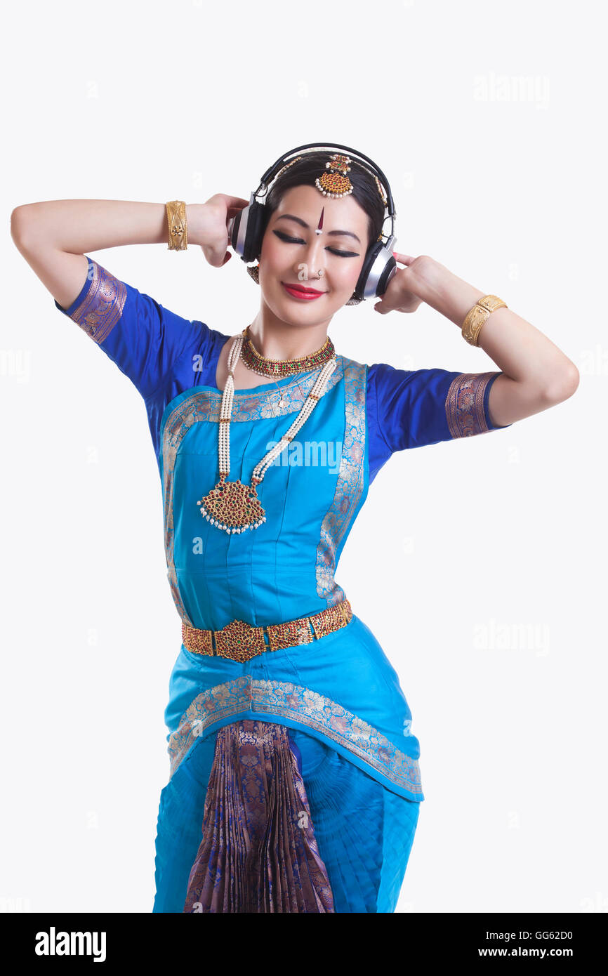 Bharatanatyam Tänzer Musik hören über Kopfhörer auf weißem Hintergrund Stockfoto