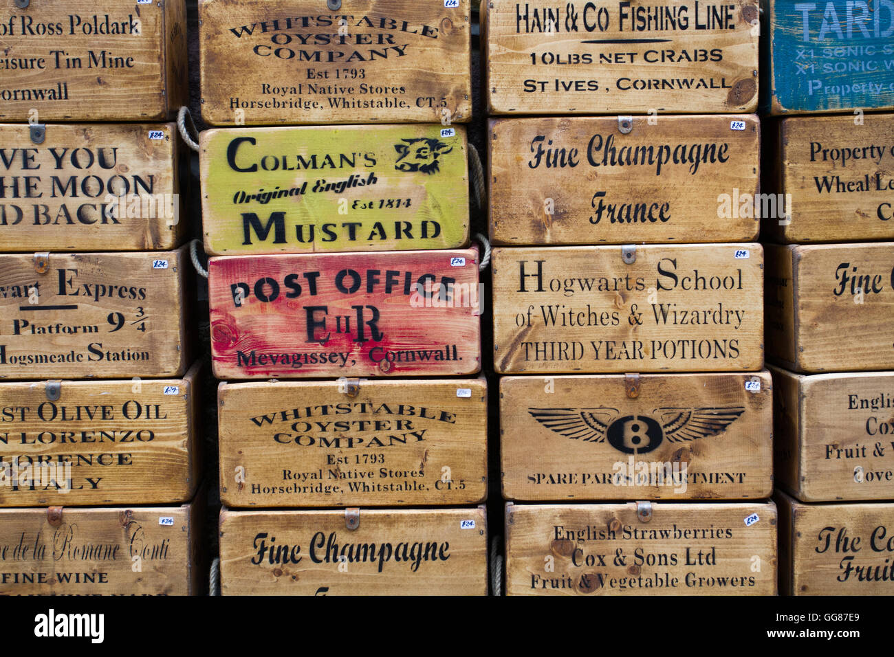 Antike und alte hölzerne Kisten übereinander gestapelt mit Anzeigen, Werbung und Nachrichten auf der Seite. Stockfoto