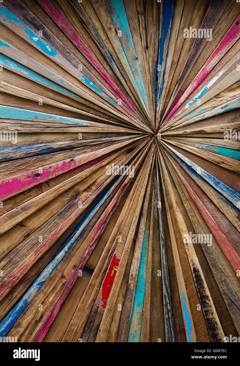 Eine abstrakte Kunst Hintergrund aus Streifen von Distressed, bunt Holz, die auf einer von der Mitte Punkt konvergieren. Stockfoto