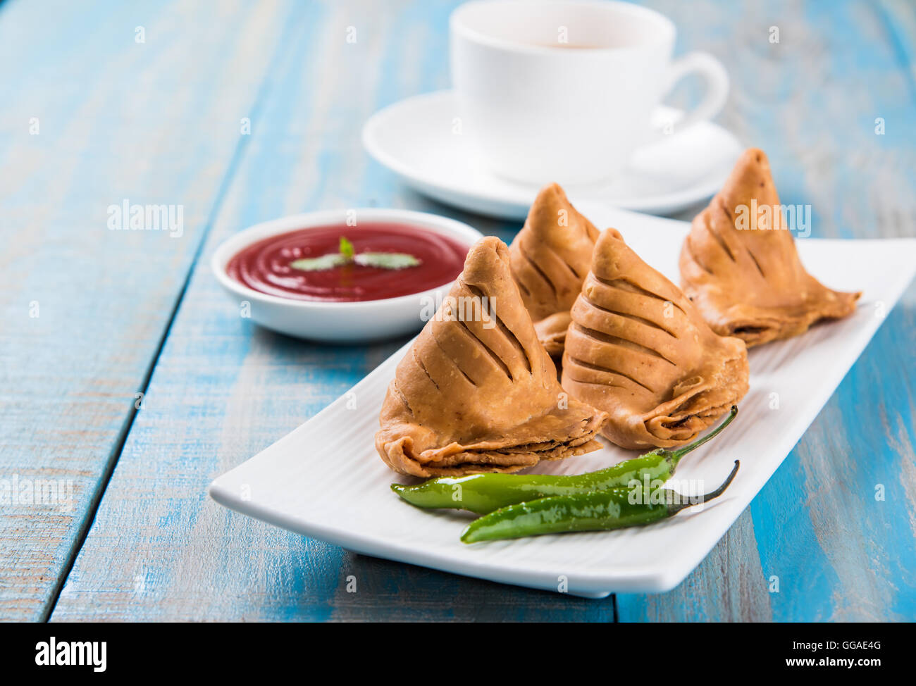 Samosa-Snack mit Tomaten-Ketchup und heißen Tee, frische Samosas mit Ketchup und bereit zum Frühstück heißen chai Stockfoto