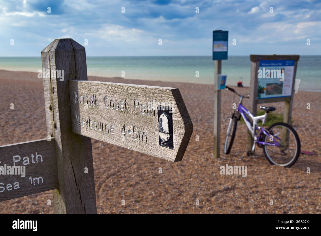 Fahrrad und Information Board bei Cley Beach North Norfolk Stockfoto