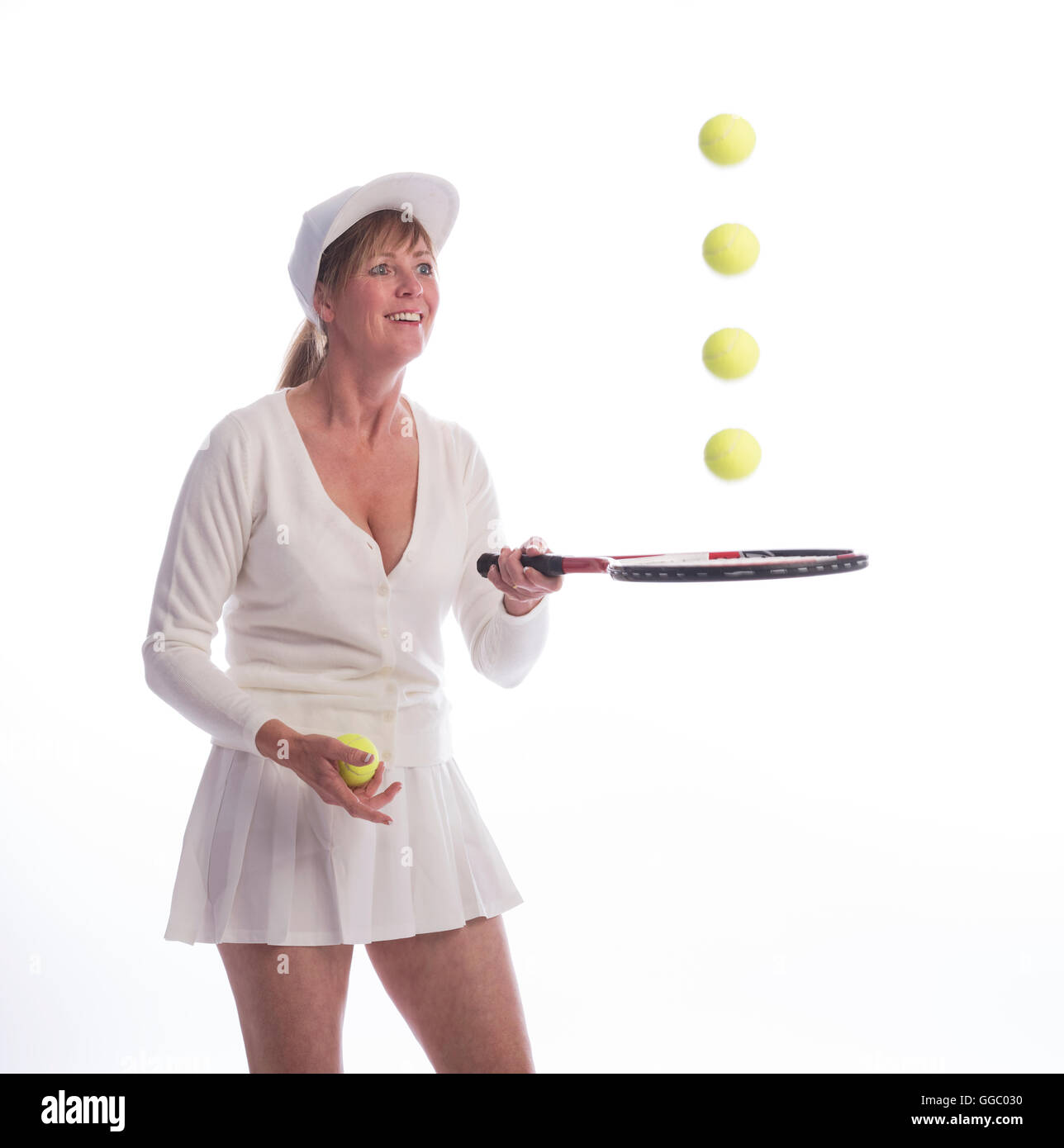 Tennis-Spielerin mit einem Schläger und springenden Bällen Stockfoto