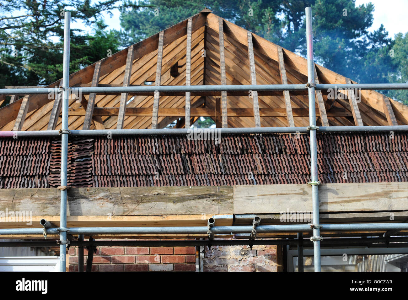 Pause in die Nässe im August erlaubt für die Bedachung und Gebäude Handel arbeiten auf den Wiederaufbau Dachbalken. Stockfoto