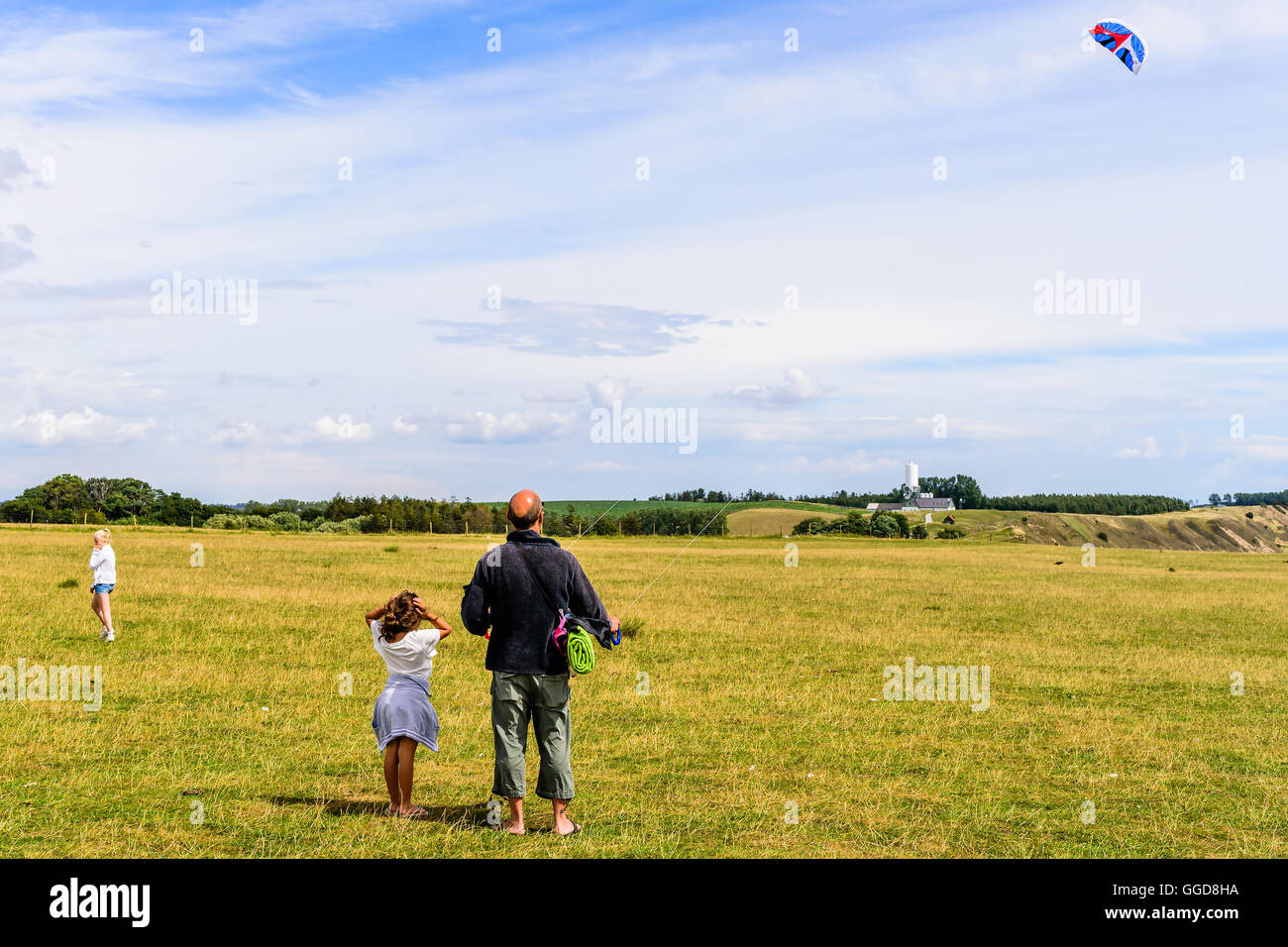 Kaseberga, Schweden - 1. August 2016: Echte Menschen im Alltag. Mann, die Drachen in einem Feld mit feinen Himmel im Hintergrund. GI Stockfoto