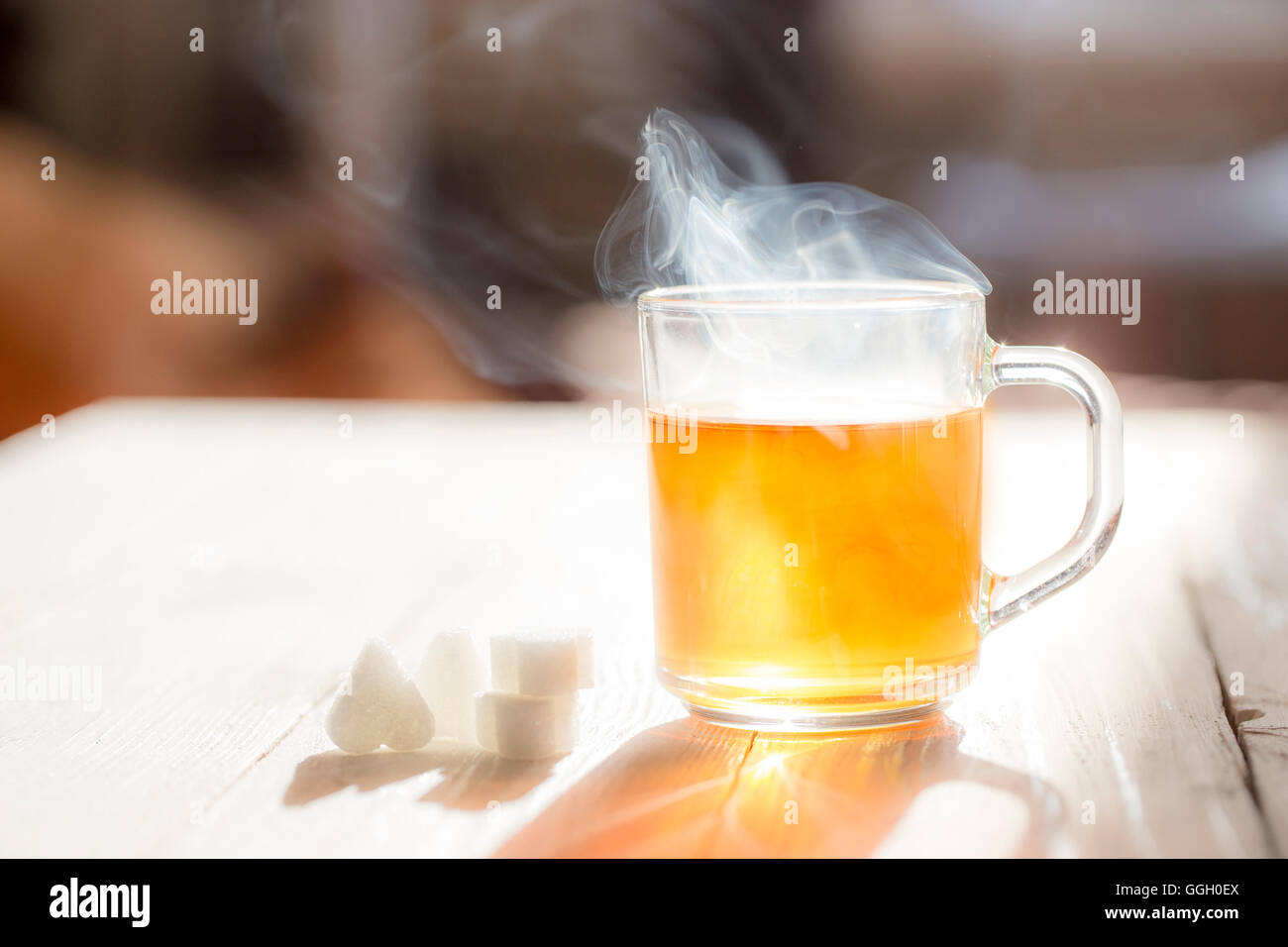 Glaskrug mit Tee am sonnigen Tag. Stockfoto