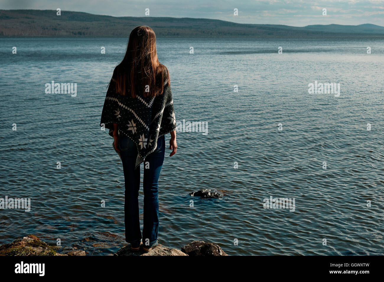 Nachdenklich kaukasische Mädchen stehen auf Felsen am See Stockfoto