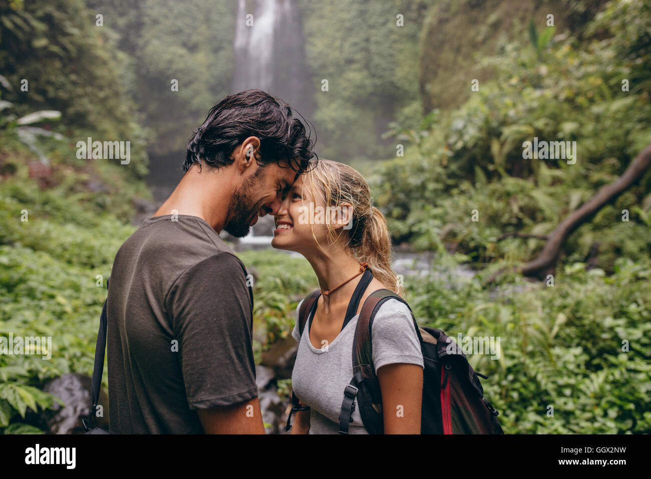 Schuss des Paares in Liebe stehend mit dem Kopf zusammen. Zärtlich junges Paar im Wald. Liebende Paar Wanderungen im Wald. Stockfoto