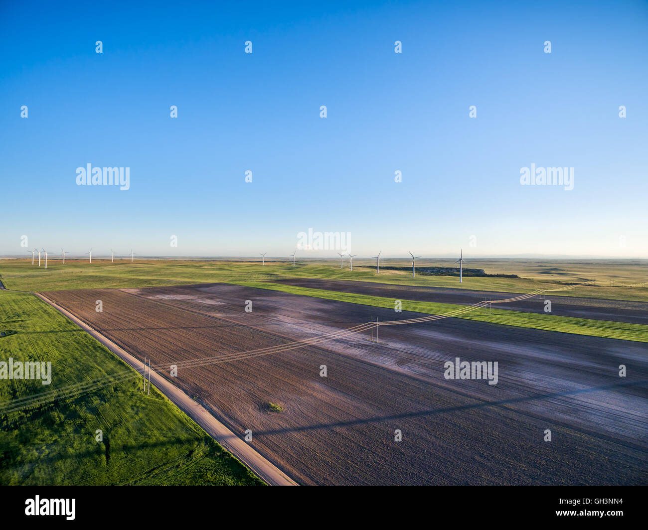 Luftaufnahme von Ackerland in Ost-Colorado - gepflügtes Feld, grüne Wiesen, Feldweg und Windpark auf Pawnee National Grassland Stockfoto