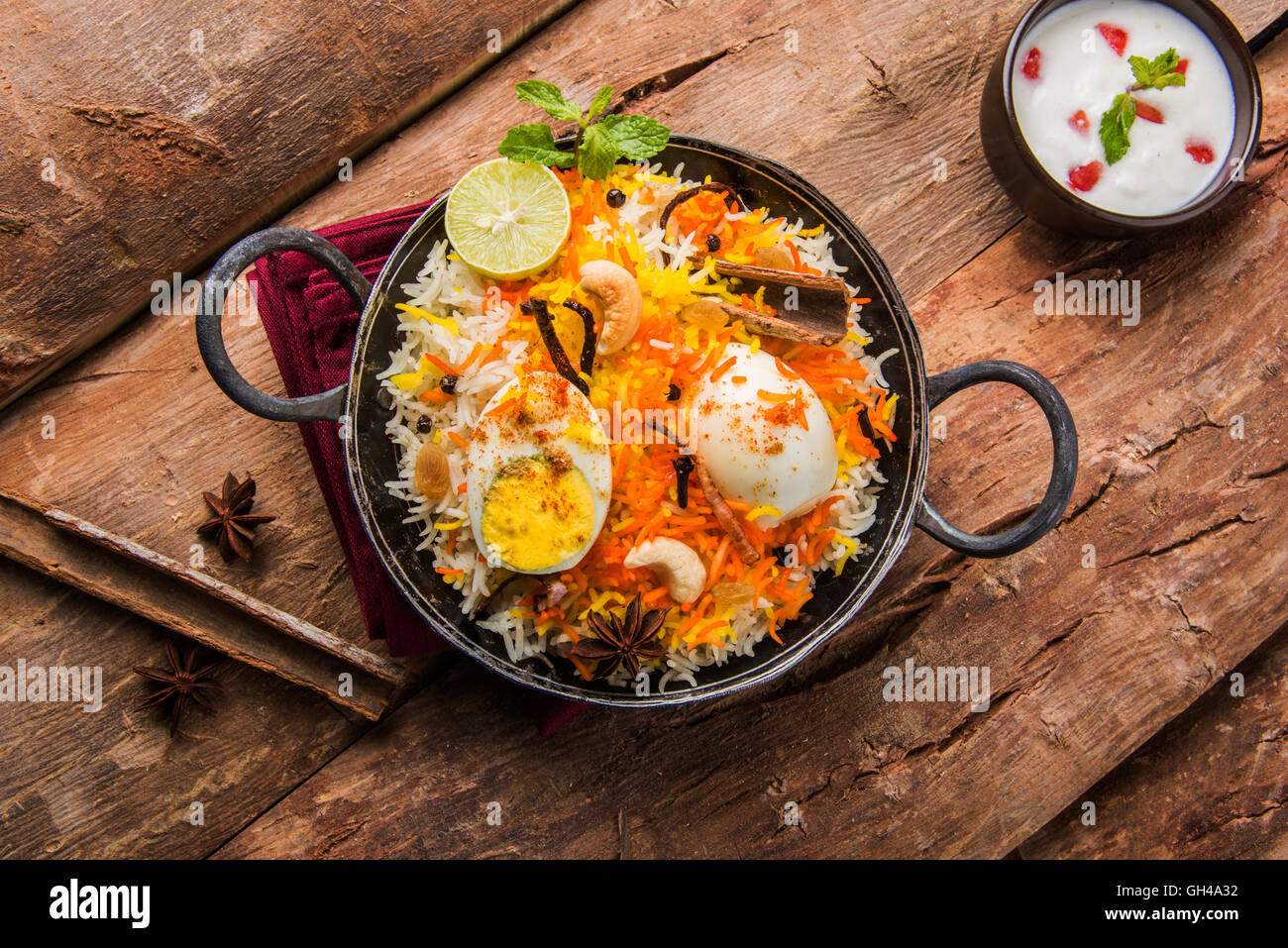 Basmati-Reis langsam gekocht, mit Masala gebratenes Ei und Gewürzen serviert in Kadhai oder Kadai mit Joghurt-Dip, selektiven Fokus Stockfoto