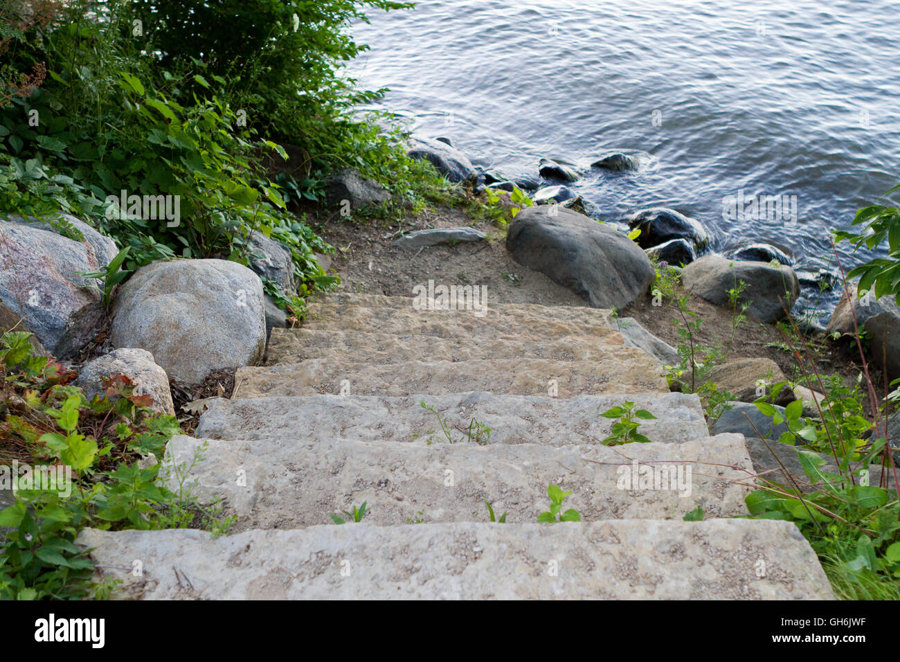 Umgeben von üppigen grünen Wälder führen Steinstufen hinunter einen Weg zum See Stockfoto