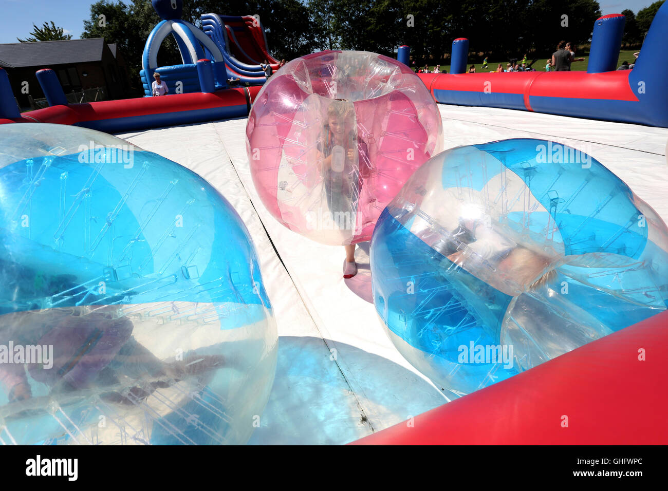 Zorbing-Spaß im Rahmen einer Sitzung im Freien spielen im Jubilee Park in North Bersted, West Sussex, UK. Dienstag, 9. August 2016. Stockfoto