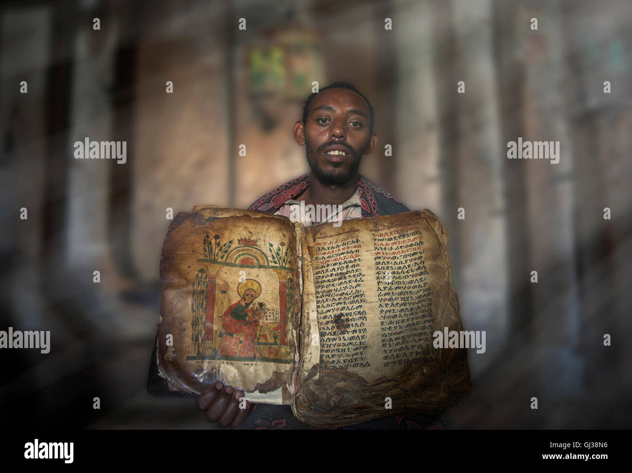 Priester zeigt ein uraltes religiöses Buch in einem orthodoxen Kloster, Tigray, Äthiopien Stockfoto