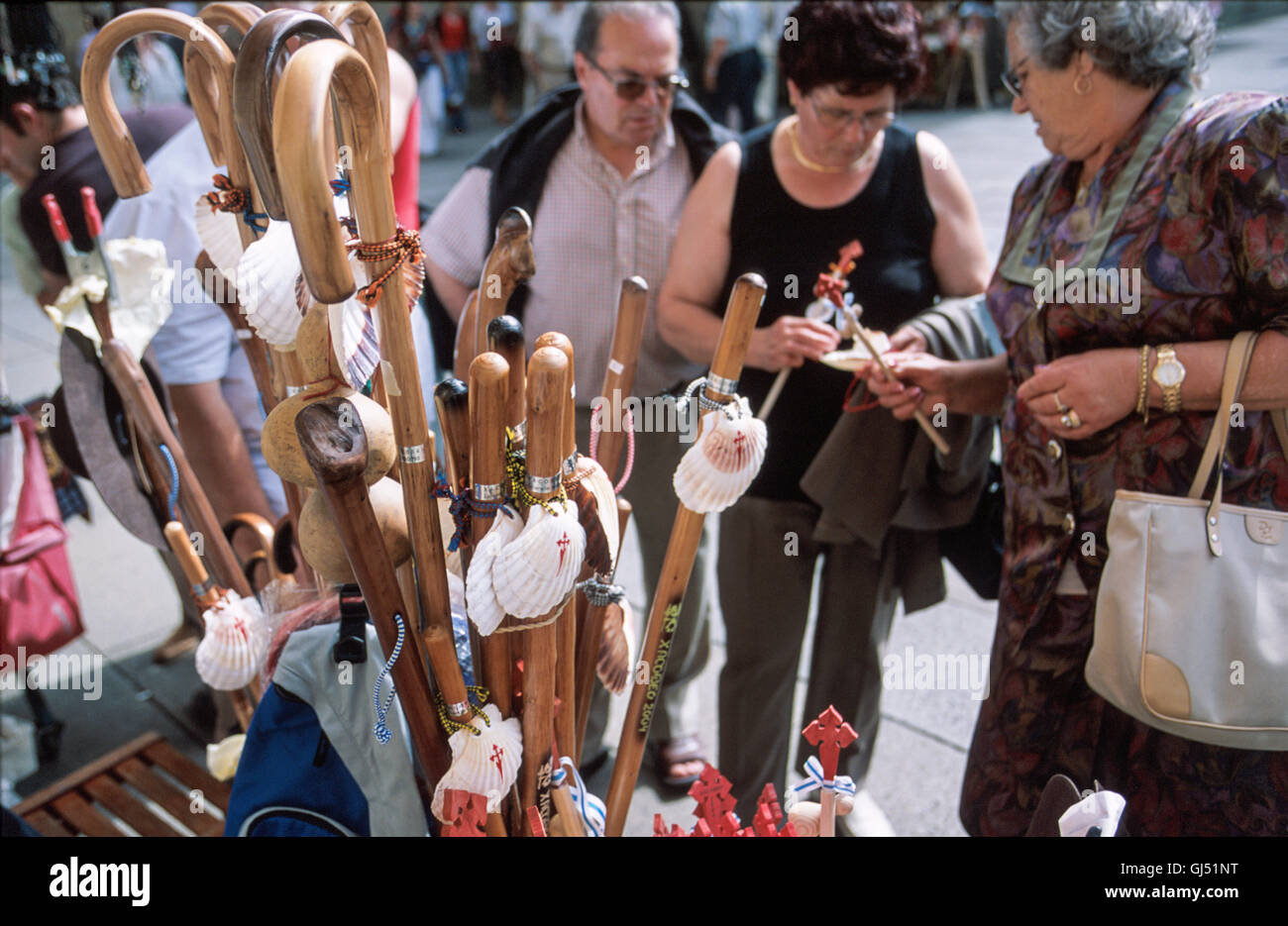 Jakobsmuscheln und Kürbisse schmücken Holzstäbe, drei Symbole des Camino, die zum Verkauf an diesem Stand auf Stockfoto