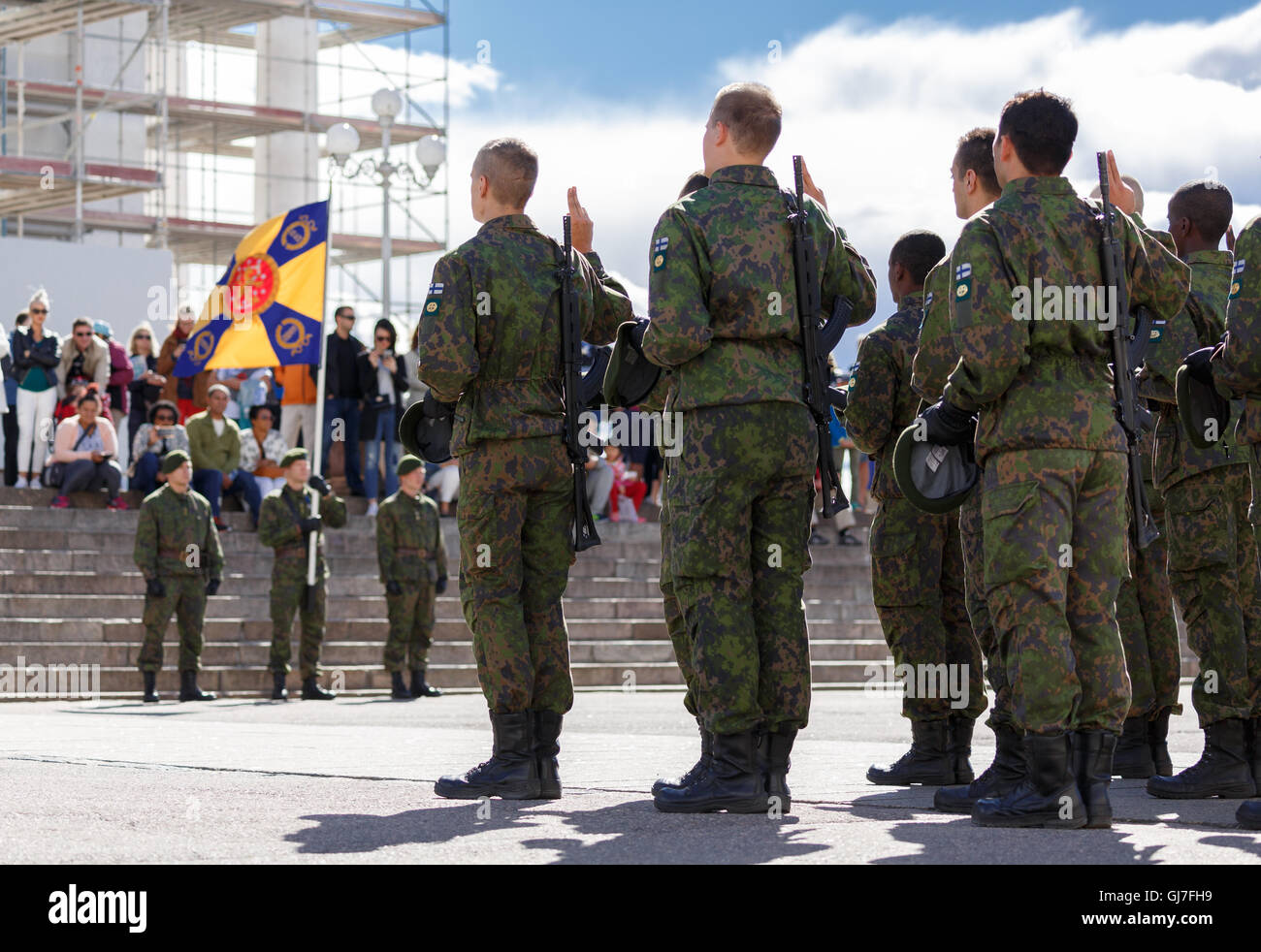 Finnische Wehrpflichtigen geben ihre militärische feierliche Versprechen in der Öffentlichkeit vor ihr Kontingent Flagge neben dem Dom von Helsinki. Stockfoto