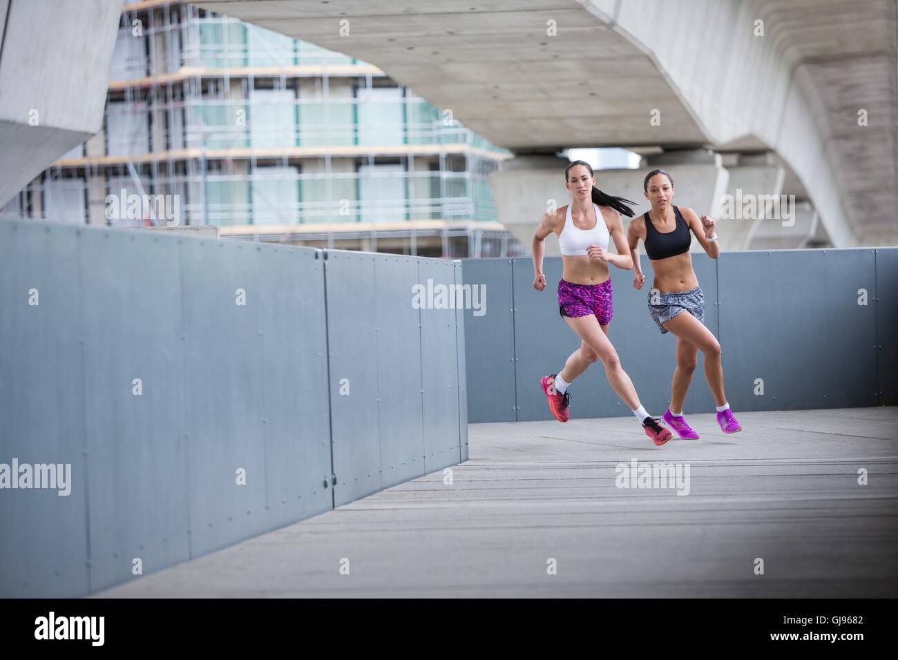 -MODELL VERÖFFENTLICHT. Zwei junge Frauen Rennen. Stockfoto