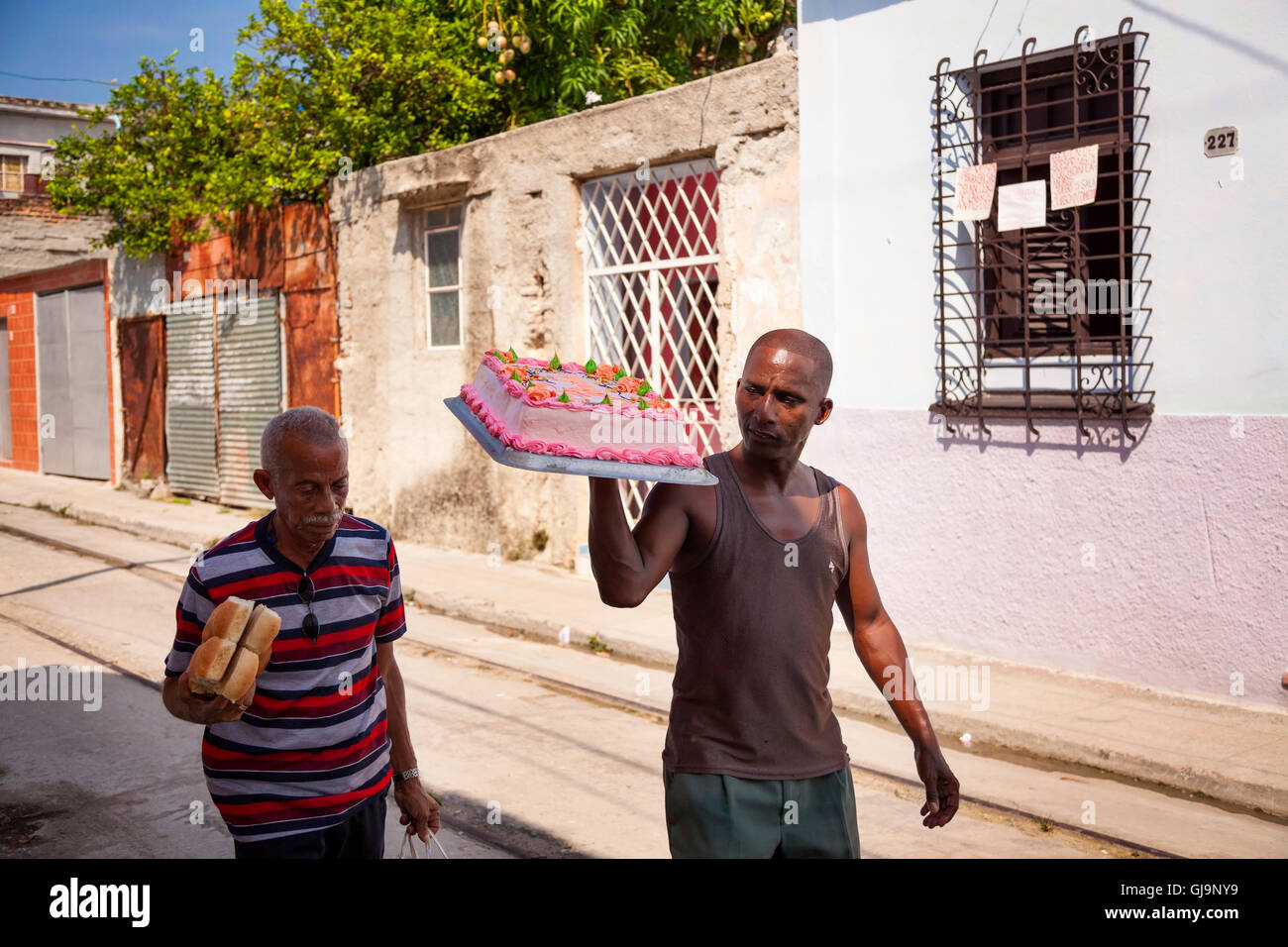 Eine kubanische tragen einen Kuchen auf der Straße in der Gemeinde von Regla, Havanna, Kuba. Stockfoto