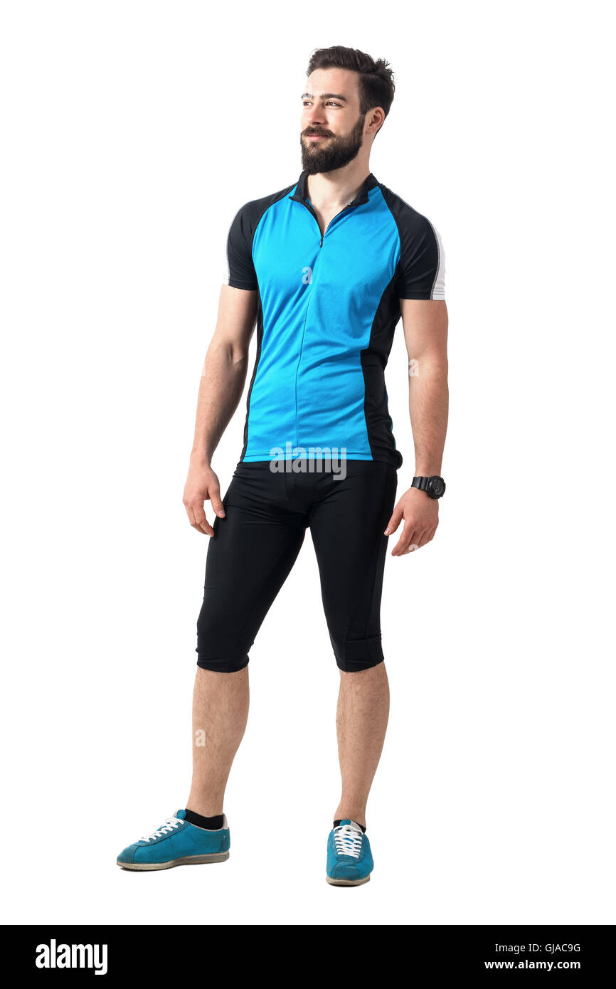 Junge bärtigen Kerl Radfahrer in blauen Trikot T-shirt und Leggings entspannt wegsehen. Ganzkörper-Länge-Porträt isoliert auf weiss Stockfoto