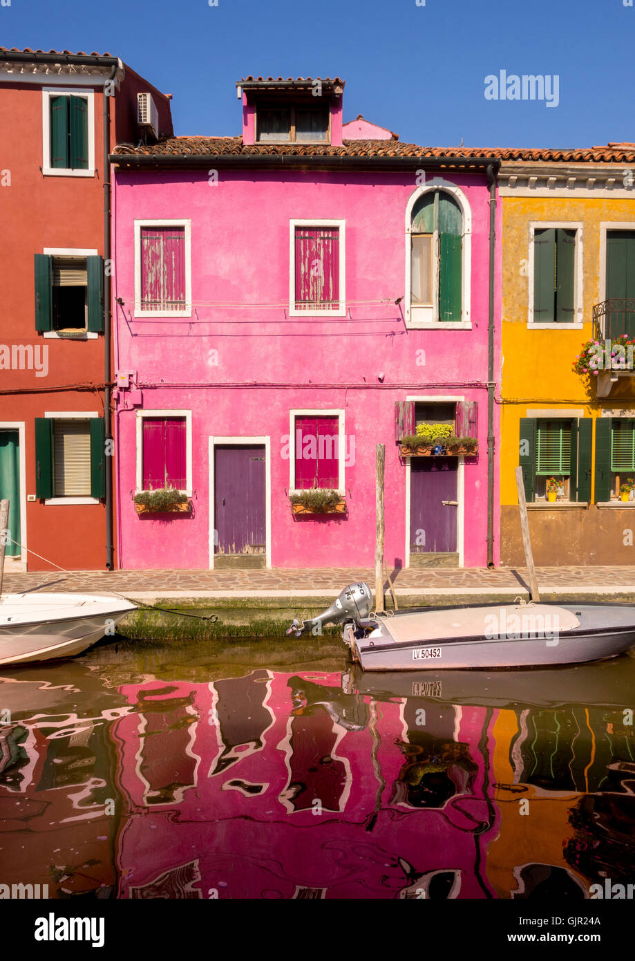 Hell gestrichene Terrassenhäuser am Canalside auf der Insel Burano. Venedig, Italien. Stockfoto