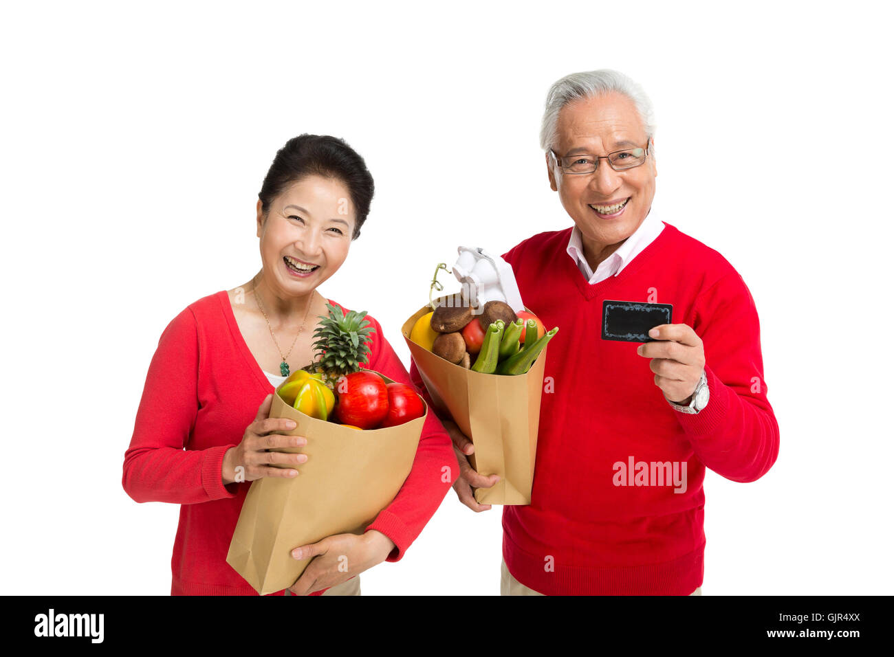 Studioaufnahme von einem älteren Ehepaar Lebensmittel einkaufen Stockfoto