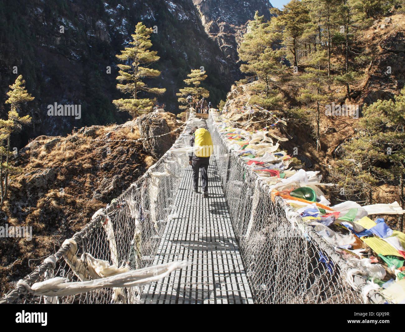 Ein Wanderer durchquert eine Hängebrücke in Nepal Everest-Basislager Stockfoto