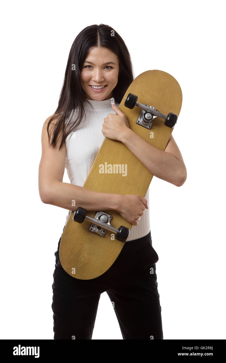 Geschäftsfrau hält eine Skateboard gedreht im studio Stockfoto