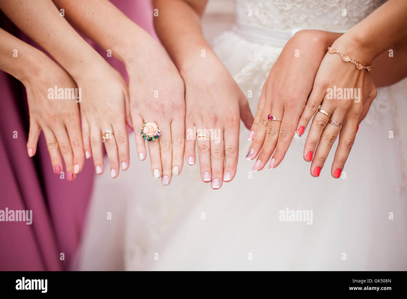 Die Braut und Brautjungfern zeigen ihre Hände mit Ringen Stockfoto
