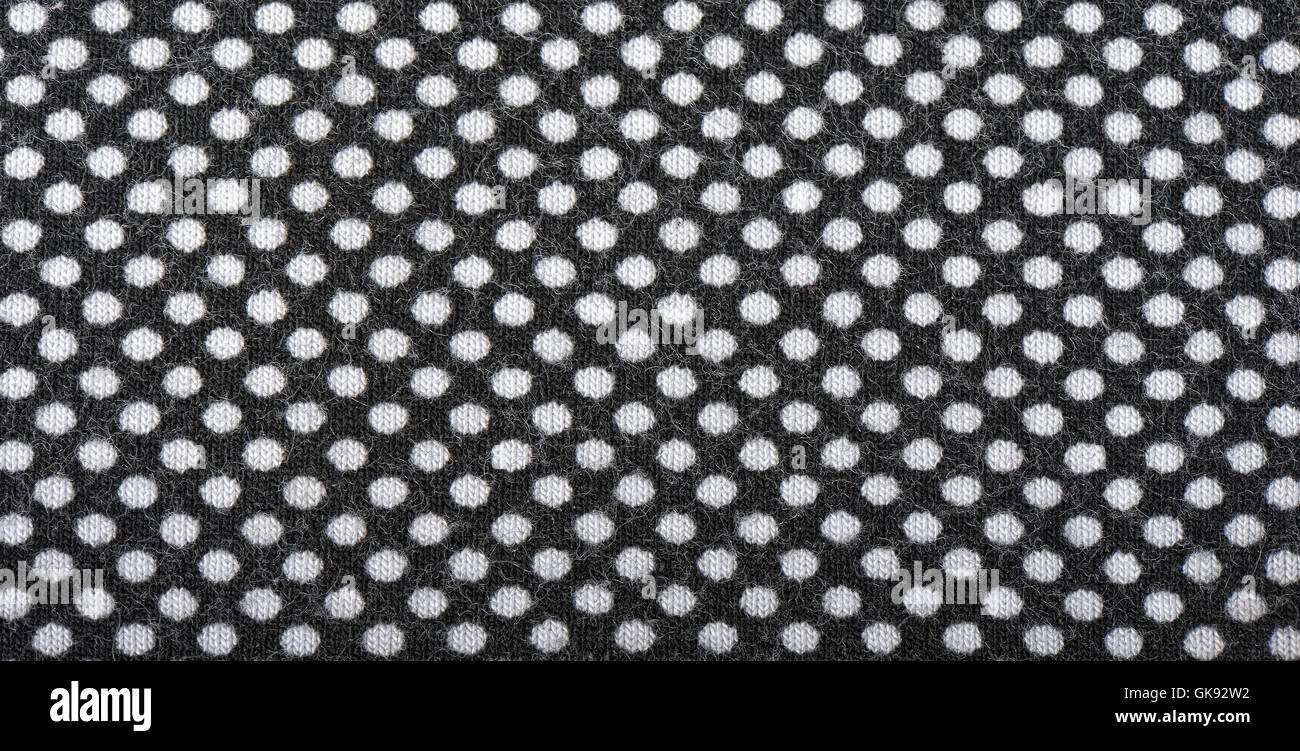 Wirkware mit weißen Tupfen, Hintergrund dunkel Stockfoto