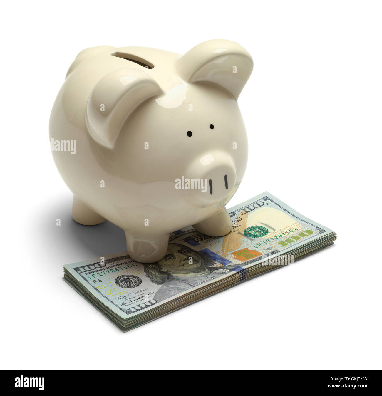 Piggy Bank stehend auf Bargeld, Isolated on White Background. Stockfoto
