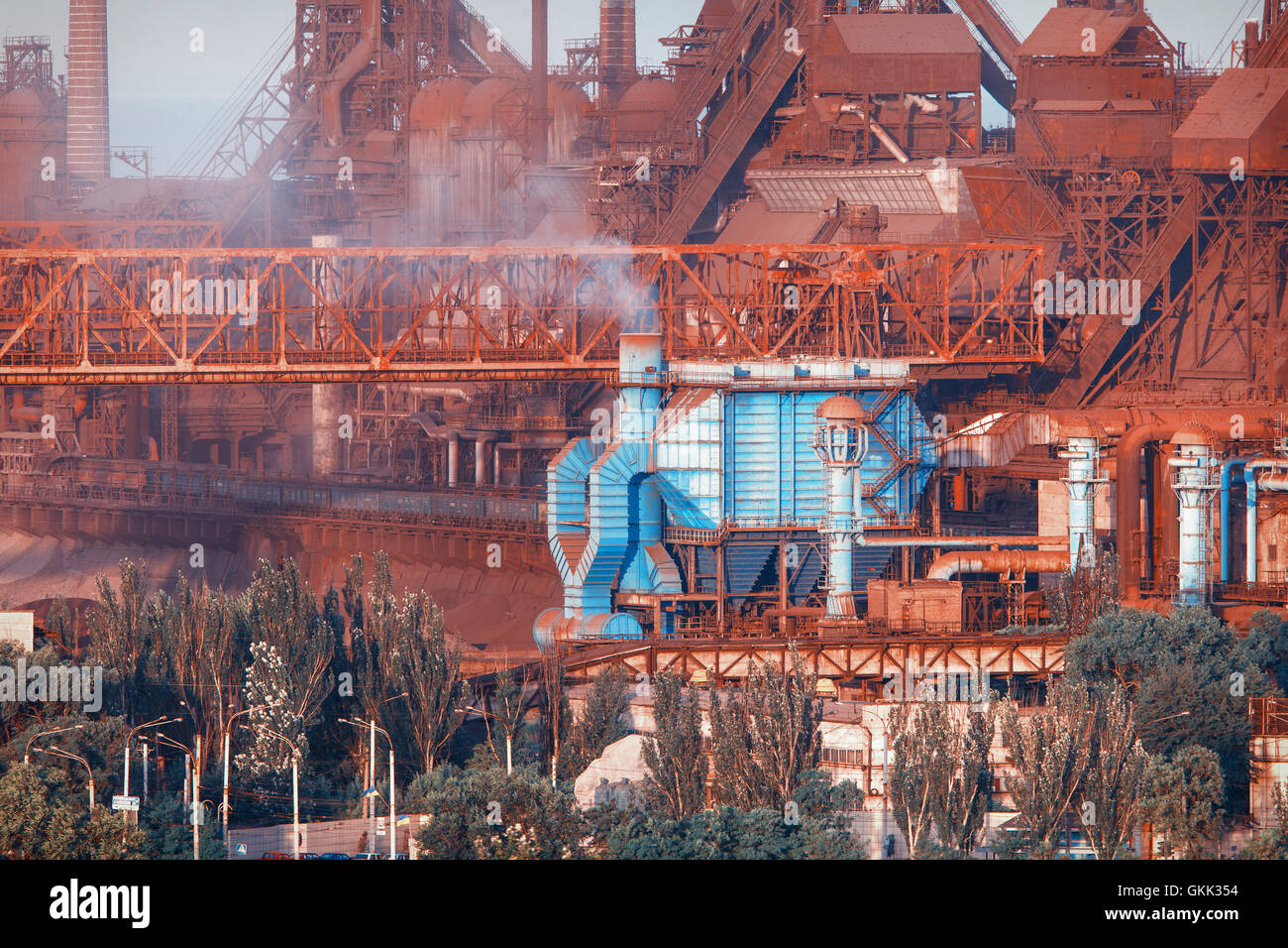 Industriebauten. Stahlwerk bei Sonnenuntergang. Rohre mit Rauch. Metallurgische Fabrik. Stahlwerke, Eisenhütte. Schwerindustrie in Stockfoto