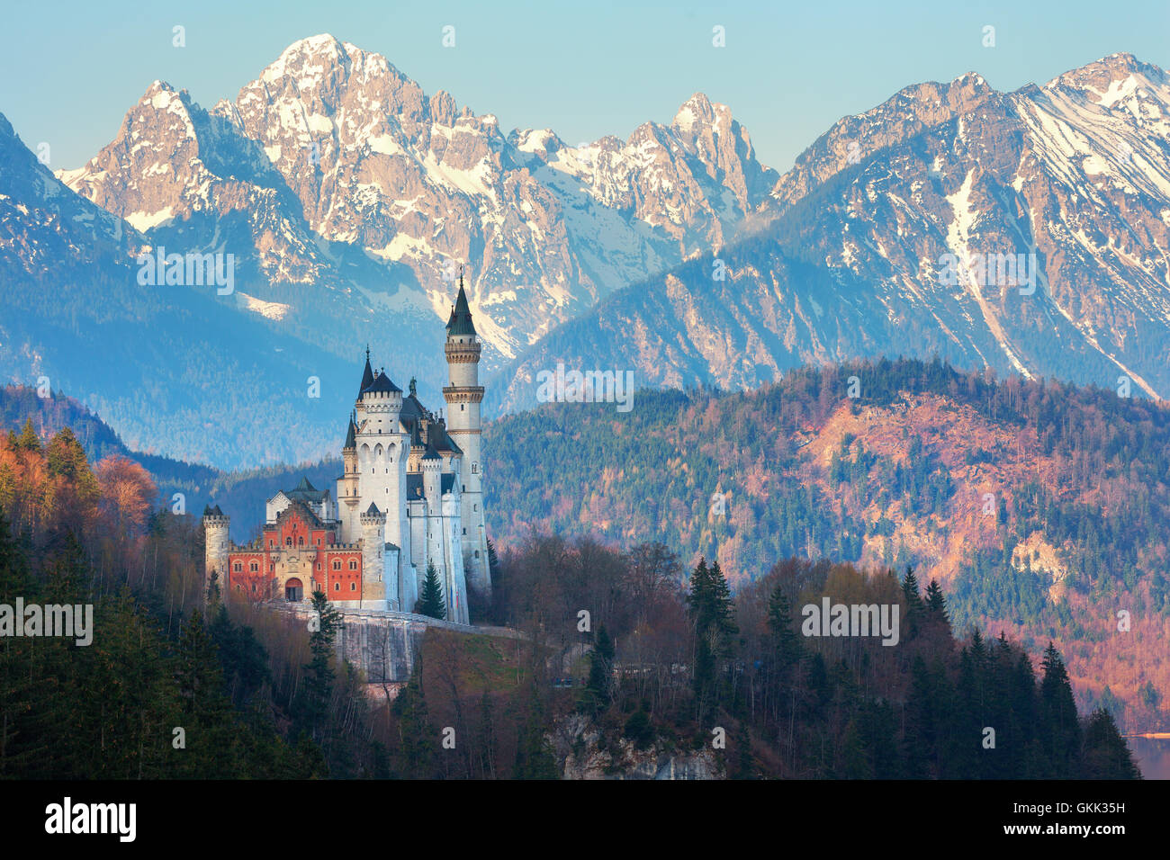 Das berühmte Schloss Neuschwanstein im Hintergrund der schneebedeckten Berge bei Sonnenaufgang in Deutschland. Schöne Frühlingslandschaft Stockfoto