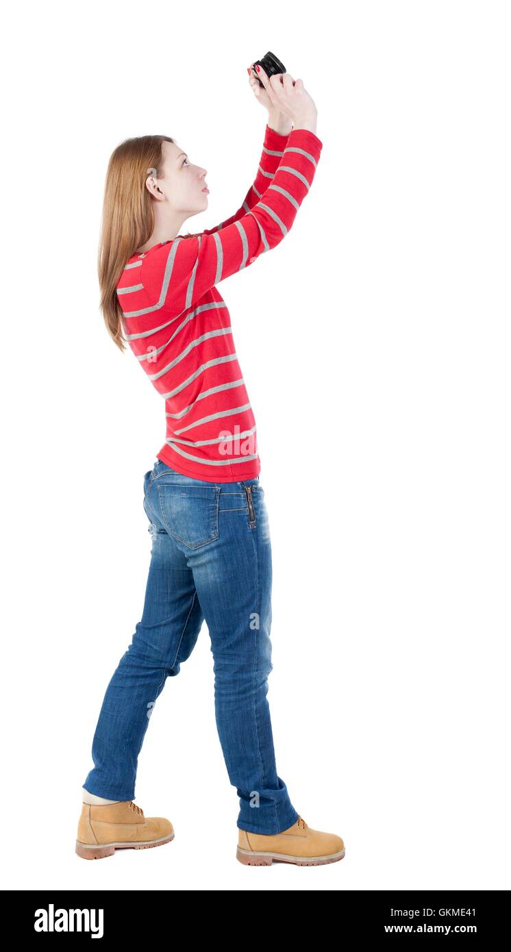 Rückansicht der Frau zu fotografieren.   Mädchen-Fotograf in Jeans. Stockfoto